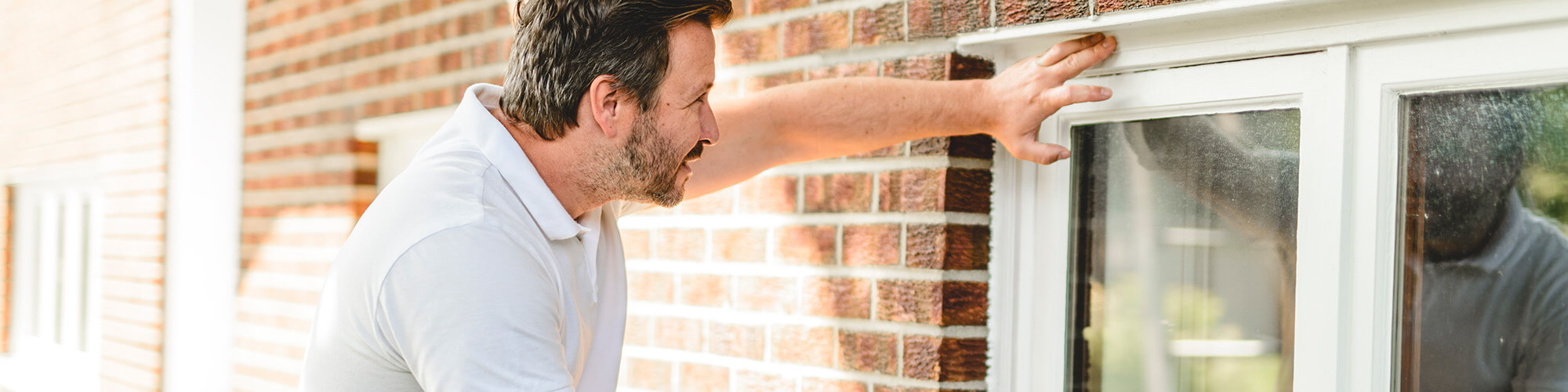 Expert window installer inspecting a window in North Carolina