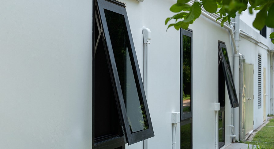Awning window shown on the side of a home in North Carolina